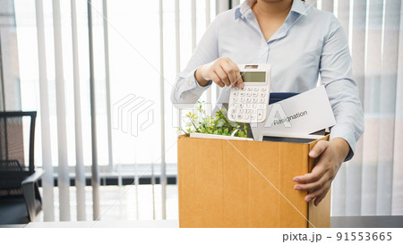 Concept of leaving job, Female employee packing personal belonging and resignation letter in box Concept of leaving job, Female employee packing personal belonging and resignation letter in box 91553665
