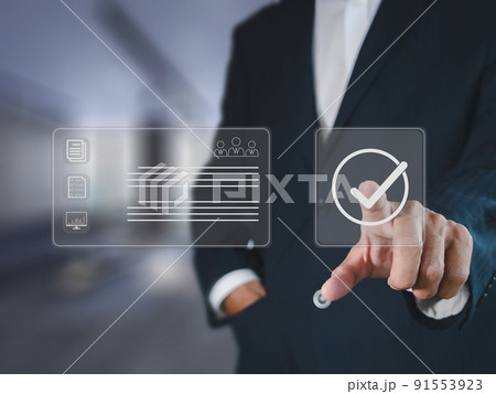 Businessman hand point check mark on virtual screen for quality control QC certification assures that the company product satisfies specifications. Businessman hand point check mark on virtual screen for quality control QC certification assures that the company product satisfies specifications. 91553923