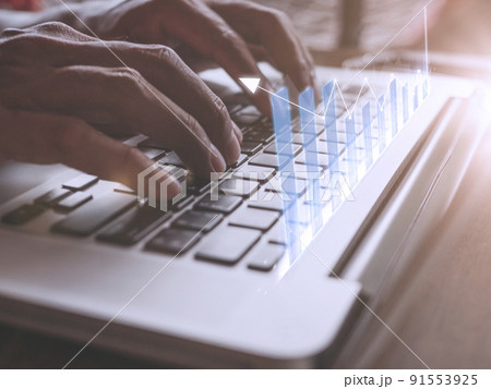 Close up hand Businessman touch enter on laptop keyboard show graph stock market bar chart grow up to target. Business finance concept Businessman analysis and success graph stocks grow set goals 91553925