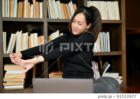 Female worker or freelancer stretching her arms, relaxes her arms 91553977