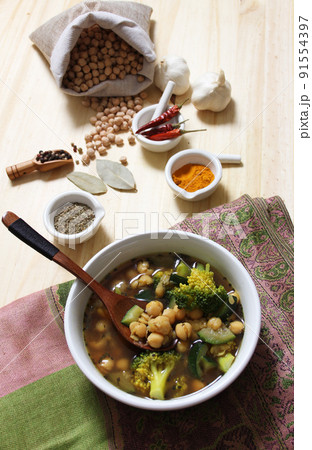 Garbanzo Beans With Zucchini and Broccoli With Spices on Rustic Table 91554397