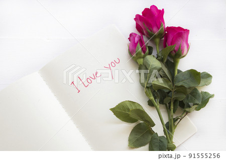 i love you message card handwriting on notebook with rose flowers  91555256