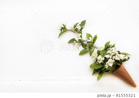 white flowers jasmine arrangement in cone flat lay postcard style 91555321