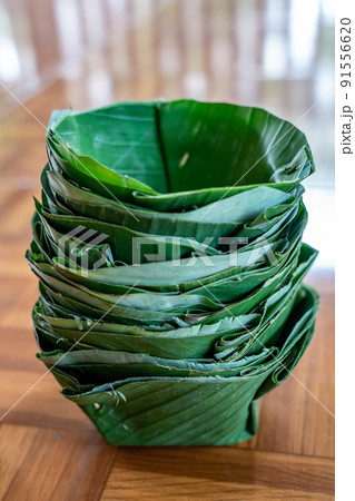 Local and traditional TRAY FOOD (eco prackaging) made to dish and bowl from banana leaf, arranged together like a tower. 91556620