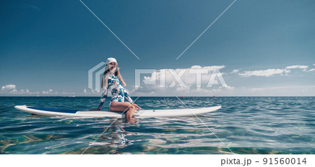 Healthy happy fit woman in bikini relaxing on a sup surfboard, floating on the clear turquoise sea water. Recreational Sports. Stand Up Paddle boarding. Summer fun, holidays travel. Active lifestyle Healthy happy fit woman in bikini relaxing on a sup surfboard, floating on the clear turquoise sea water. Recreational Sports. Stand Up Paddle boarding. Summer fun, holidays travel. Active lifestyle 91560014