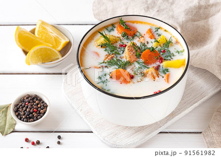 Lohikeitto, Finnish creamy salmon soup in a white bowl 91561982