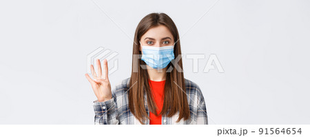 Coronavirus outbreak, leisure on quarantine, social distancing and emotions concept. Cheerful attractive woman in medical mask showing number four, make order, white background Coronavirus outbreak, leisure on quarantine, social distancing and emotions concept. Cheerful attractive woman in medical mask showing number four, make order, white background 91564654