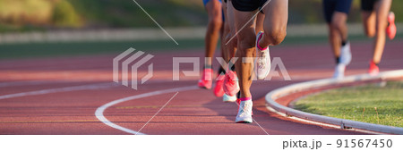 Athletics people running on the track field.Running a race on a track for sports competition and winning 91567450