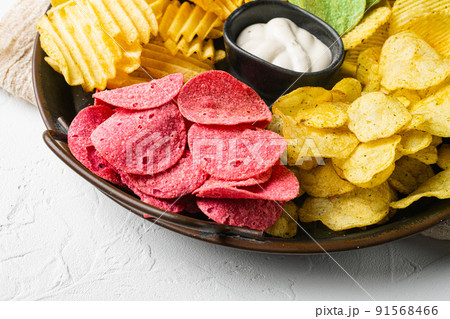 Variation different potato chips on white stone table background 91568466