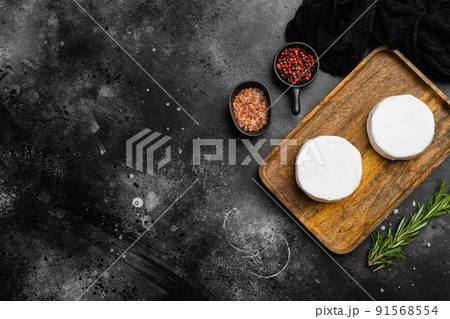 Fresh Brie cheese on black dark stone table background, top view flat lay, with copy space for text Fresh Brie cheese on black dark stone table background, top view flat lay, with copy space for text 91568554