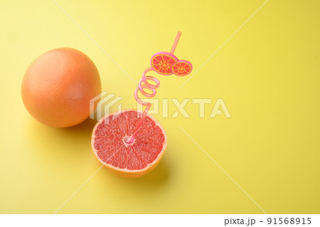 Juicy pink grapefruit cut , on yellow textured summer background, with copy space for text 91568915
