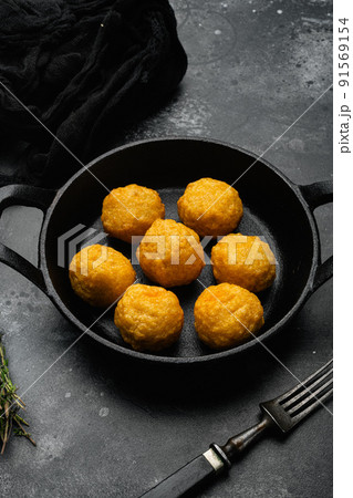 Battered meat on black dark stone table background Battered meat on black dark stone table background 91569154