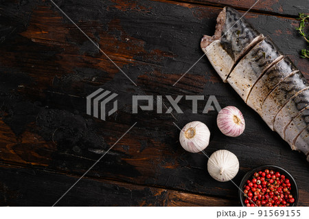 Mediterranean salted mackerel, on old dark wooden table background, top view flat lay, with copy space for text Mediterranean salted mackerel, on old dark wooden table background, top view flat lay, with copy space for text 91569155