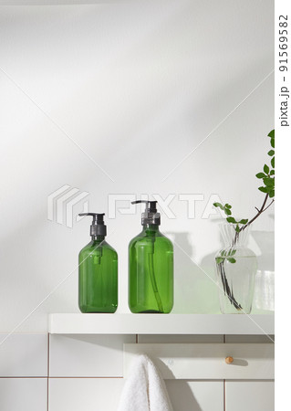 Top view of cosmetic jar in white bathroom with glassware and flower for cosmetic advertising , lifestyle content 91569582