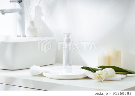 Cosmetics product and cotton towels, cottons pad with green plant on white table inside a bathroom background ceramic. 91569592
