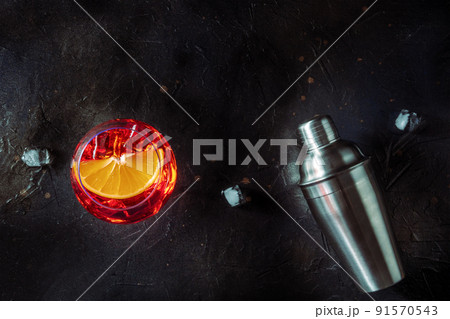 Aperol cocktail with a fresh orange slice and a shaker, Italian cold drink 91570543