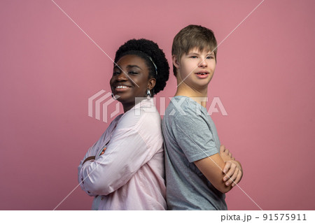 Woman and boy standing back to back 91575911