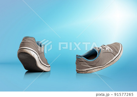 Urban sports shoes over blue background. Sneakers or trainers isolated. Athletic shoes. fitness, sport, training concept. Urban fashion 91577265