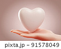 Hand holding white heart over pink background. Concept of love, valentine and support. 3D rendering. 91578049
