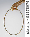 Golden female hand holding round golden frame. Background for cosmetics, fashion, product show. 3D rendering. 91578076