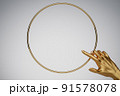 Human golden hand pointing in golden ring frame. Background for cosmetics, fashion, product show. 3D rendering. 91578078