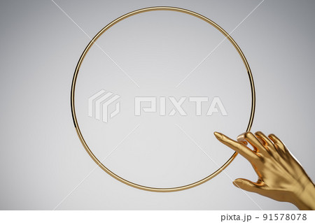 Human golden hand pointing in golden ring frame. Background for cosmetics, fashion, product show. 3D rendering. Human golden hand pointing in golden ring frame. Background for cosmetics, fashion, product show. 3D rendering. 91578078
