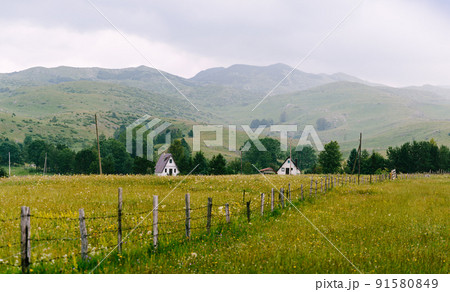 Houses fenced with a wooden palisade in the north of Montenegro Houses fenced with a wooden palisade in the north of Montenegro 91580849