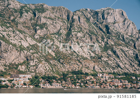 Old stone houses at the foot of the mountain range on the shore of the Bay of Kotor 91581185