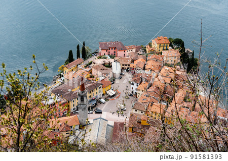 Orange tiled roofs of old houses on the shores of Lake Como. Top view 91581393