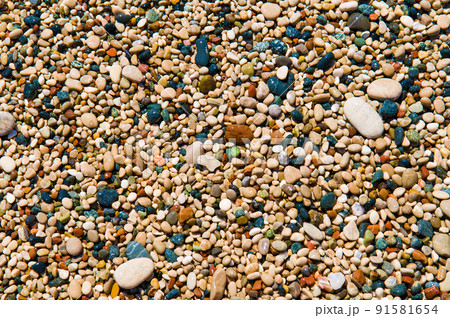 Multi-colored wet pebbles on the beach of the Mediterranean Sea. Colorful background. Multi-colored wet pebbles on the beach of the Mediterranean Sea. Colorful background. 91581654