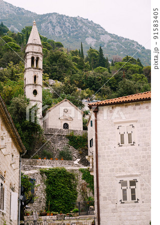 Church of Our Lady of the Rosary on a background of mountains. Perast, Montenegro 91583405