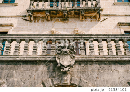 Balustrade of an old building with a coat of arms on the wall. Perast, Montenegro Balustrade of an old building with a coat of arms on the wall. Perast, Montenegro 91584101