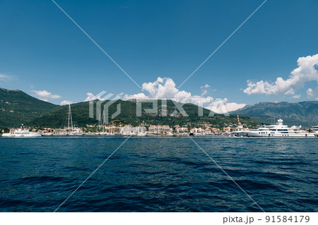 White yacht sails to the coast of the expensive resort of Porto. Montenegro 91584179