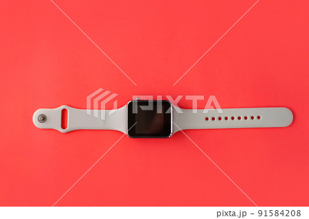 Smart watch with white silicone band side view on pink coral background. Trendy sports style watches on bracelet, Smart watch with white silicone band side view on pink coral background. Trendy sports style watches on bracelet, 91584208