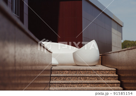 Modern exterior of corporate building, terrace with stone contemporary furniture 91585154