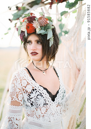 Bride in a wreath stands near the wedding arch Bride in a wreath stands near the wedding arch 91585682