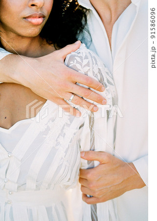 Man hugs a woman by the shoulders. Close-up Man hugs a woman by the shoulders. Close-up 91586096