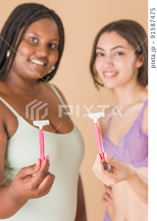 hair removal body care depilation with razor. skin cosmetology with Latin Cuban and Moroccan woman 91587475