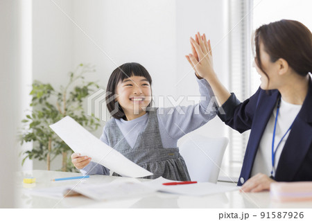 学習塾でテストの結果を喜ぶ女の子 小学生  91587926