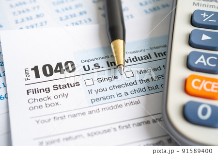 Tax Return form 1040 with USA America flag and dollar banknote, U.S. Individual Income. 91589400