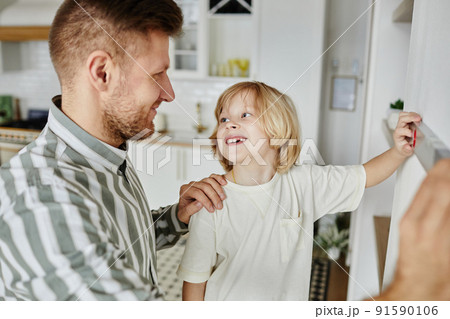 Little Boy Helping Father with Home Improvement 91590106