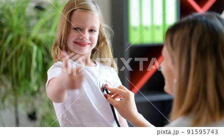 Happy smiling girl at doctor pediatrician appointment 91595743