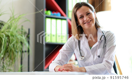 Smiling female doctor posing in clinic office 91595746