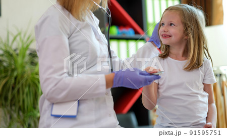 Smiling little kid at doctor pediatrician appointment 91595751