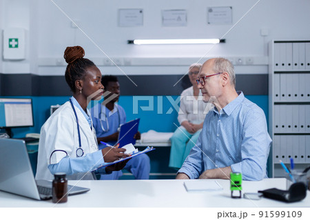 Healthcare clinic specialist taking notes about sick elderly patient health condition while recommending advanced consultation and examination. Hospital practitioner writing on clipboard illness 91599109