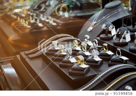 Gold jewelry diamond shop with rings and necklaces luxury retail store window display showcase 91599856