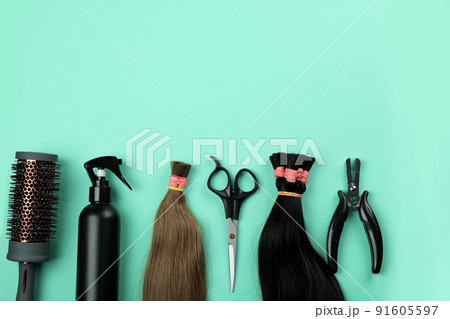 Composition with hair extension accessories on mint background Composition with hair extension accessories on mint background 91605597