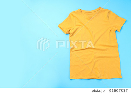 Blank yellow t-shirt with space for print on blue background Blank yellow t-shirt with space for print on blue background 91607357