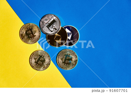 Heap of digital currency golden and silver on yellow and blue background 91607701