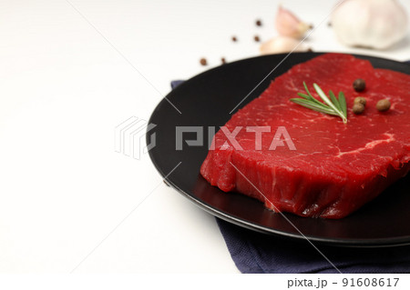 Concept of cooking with raw steak on white background 91608617